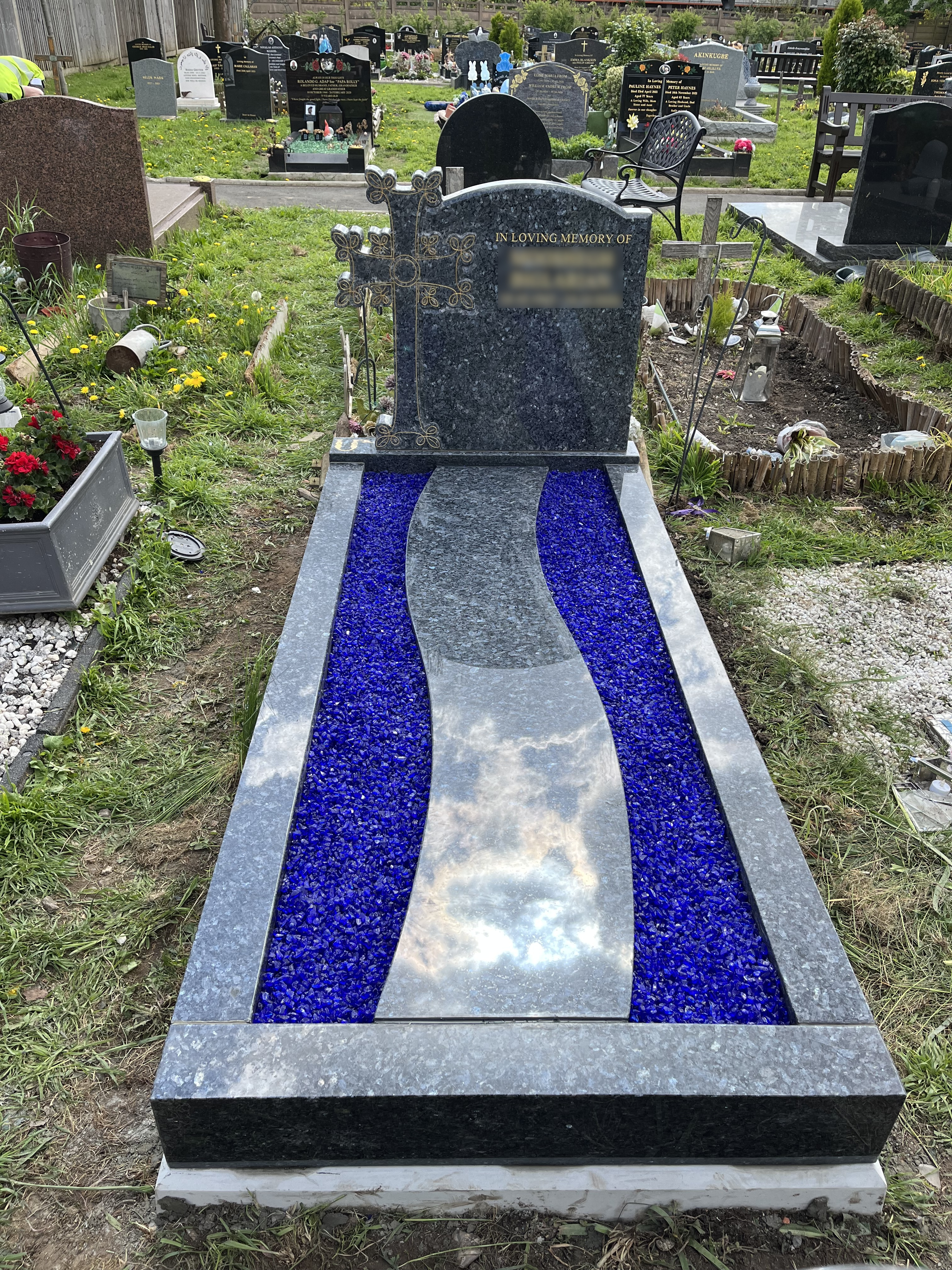 A blue pearl full memorial with a carved Armenian cross, gold detailing added to highlight this. A path has been added down to the centre of the memorial