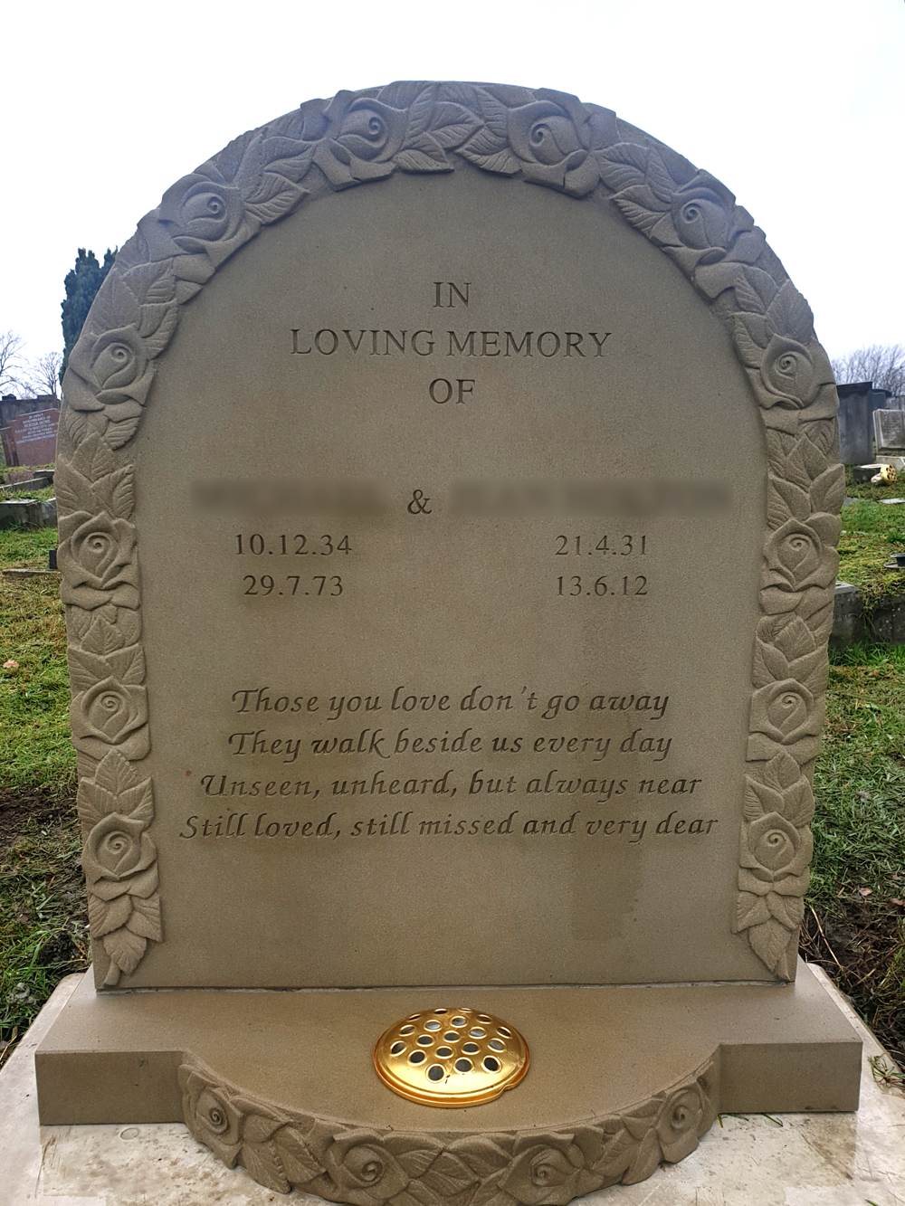York stone lawn memorial with carved roses and bow fronted base.