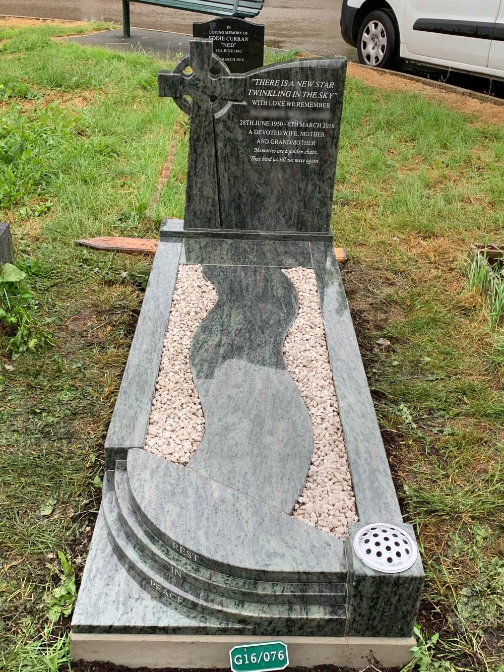 Kerala Green Granite full memorial with Celtic Cross style headstone with chamfers on headstone and winding path down centre and quadrant steps and chippings.