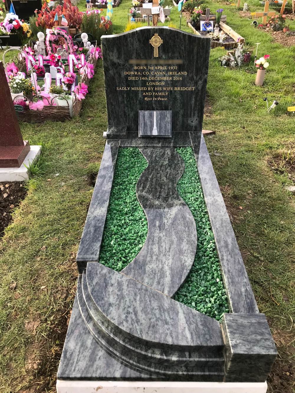 Kerala Green granite ogee top headstone upon kerb set incorporating a winding path and quadrant steps with token book and green chippings.