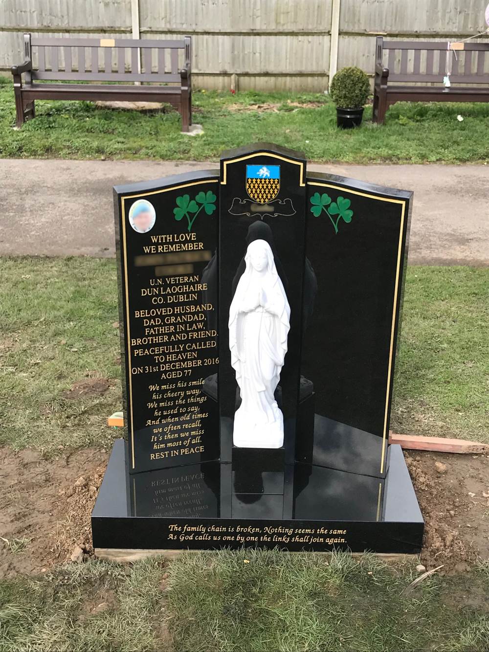 Black Granite winged lawn memorial with gold pin line and Our Lady Statue.