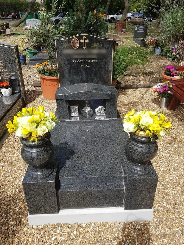 South African dark grey full memorial, with pin line, cover slab, candle box and turned vases on foot posts.