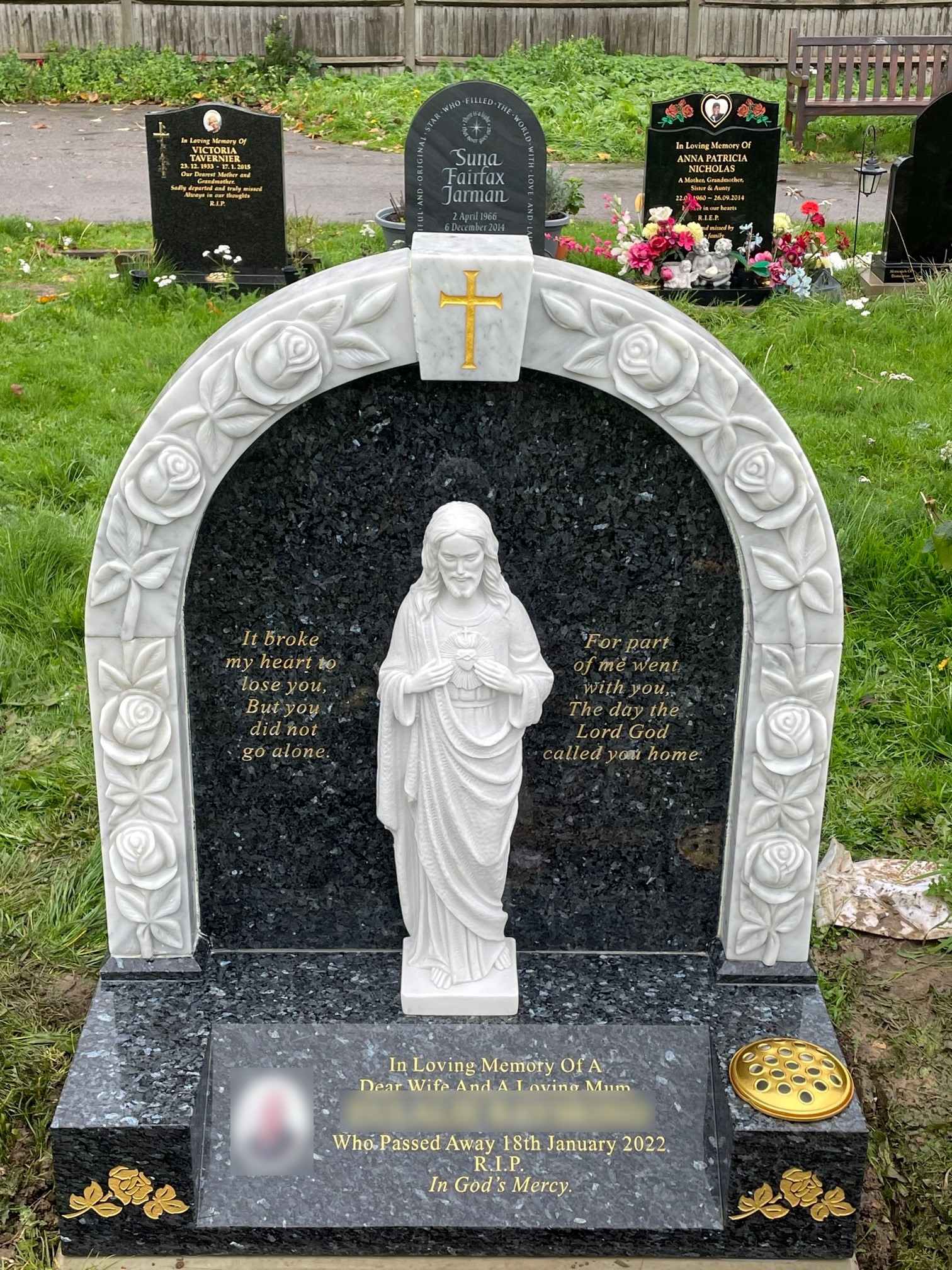 Blue Pearl granite and White Marble lawn memorial with hand carved roses and Sacred Heart Jesus statue.