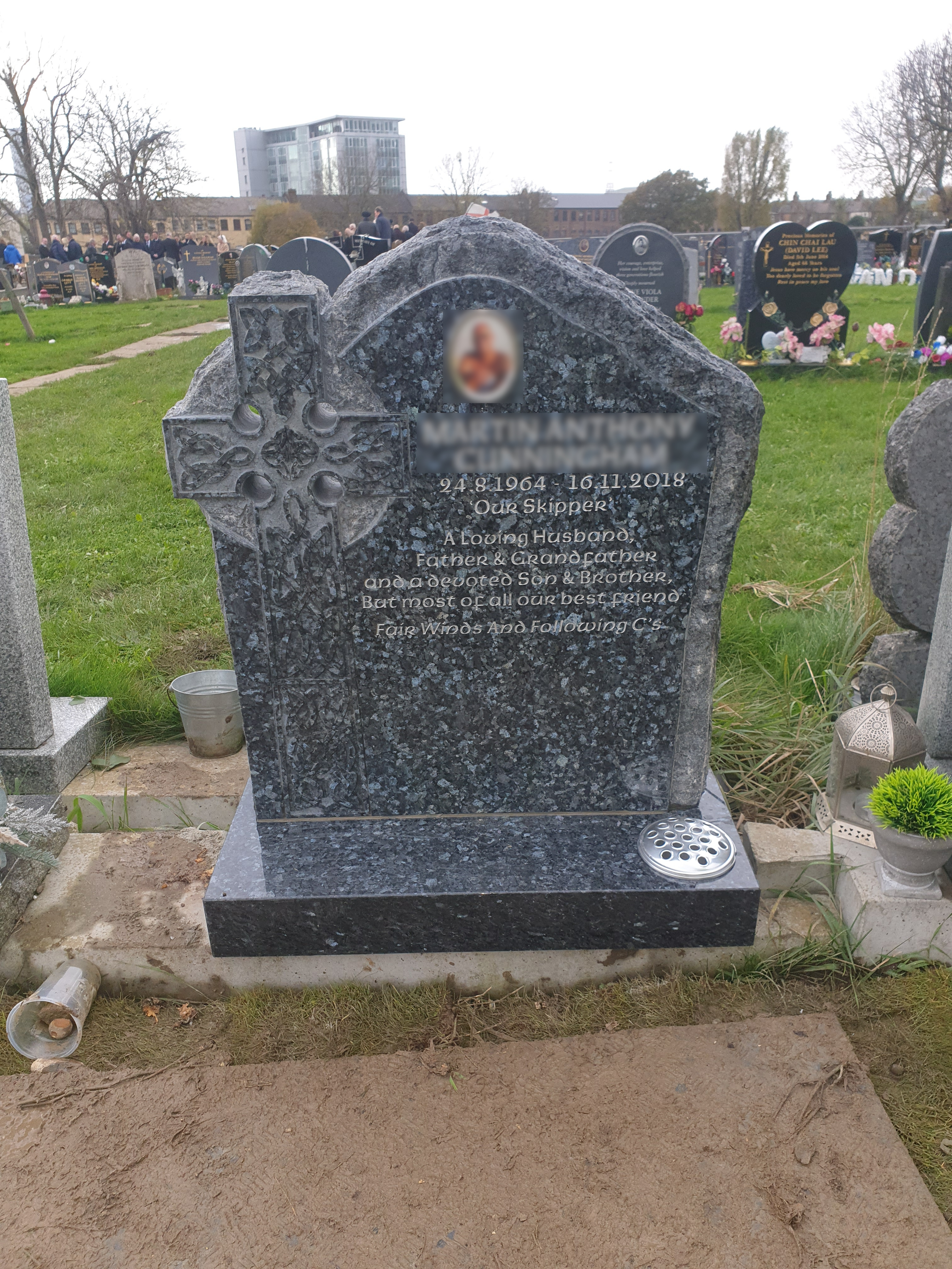 Blue Pearl granite lawn memorial with rustic edge and integrated Celtic Cross.