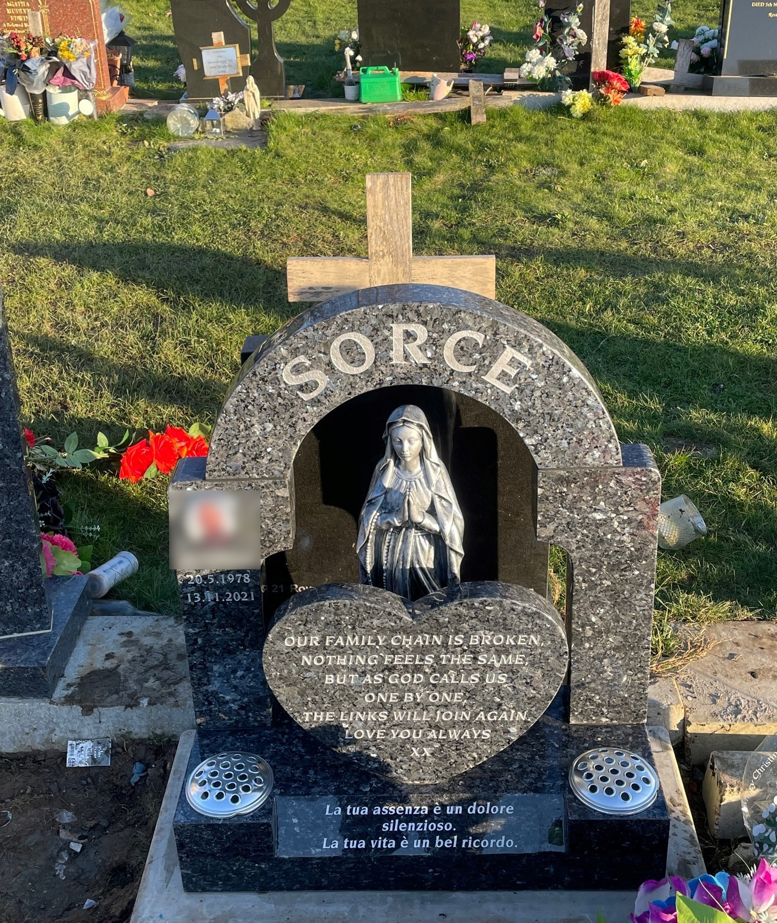 Blue Pearl granite arch top lawn memorial with large central heart token for inscription and Our Lady statue.