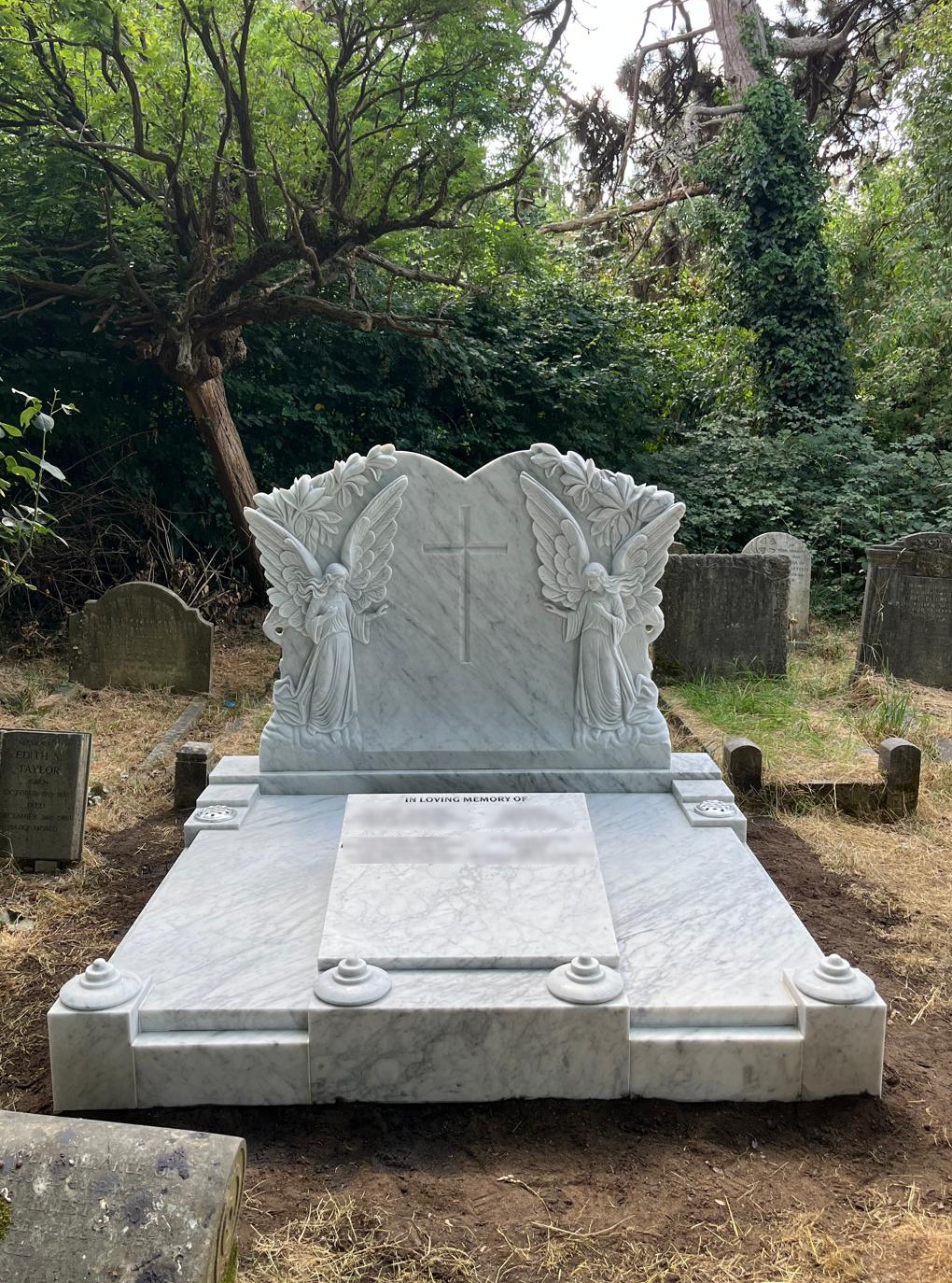 Exquisitely hand carved double Angel memorial in white Italian marble. With cover slab and marble wedge for lettering.
