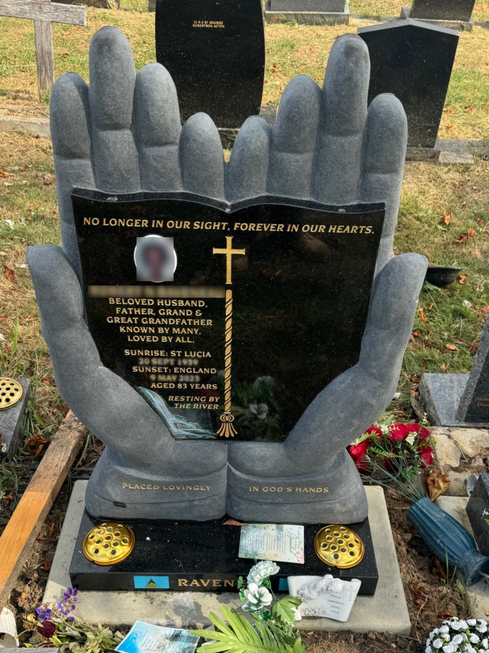 Exquisitely hand carved hands holding a polished bible in Star Galaxy Granite.