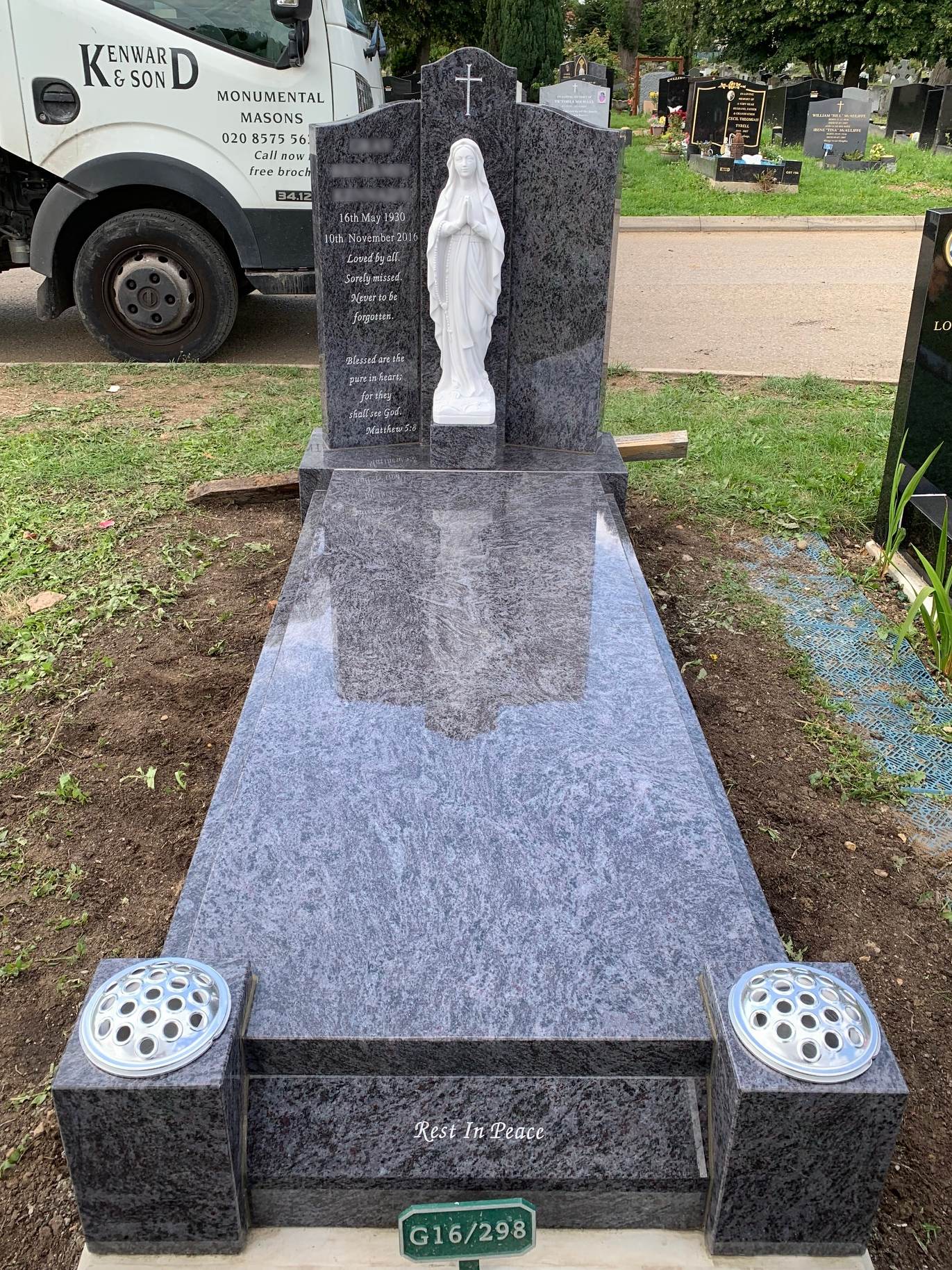 Bahama Blue Granite winged memorial with Our Lady Statue, cover slab and splayed foot kerb.